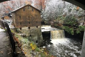 Lanterman's Mill and falls in Mill Creek Park, Youngstown, with fall leaves and early snow